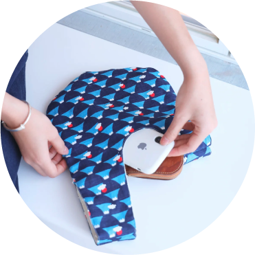 Blue Fuji Moonshell Bag capacity demonstration with phone and wallet at Grandmama Store in Hong Kong