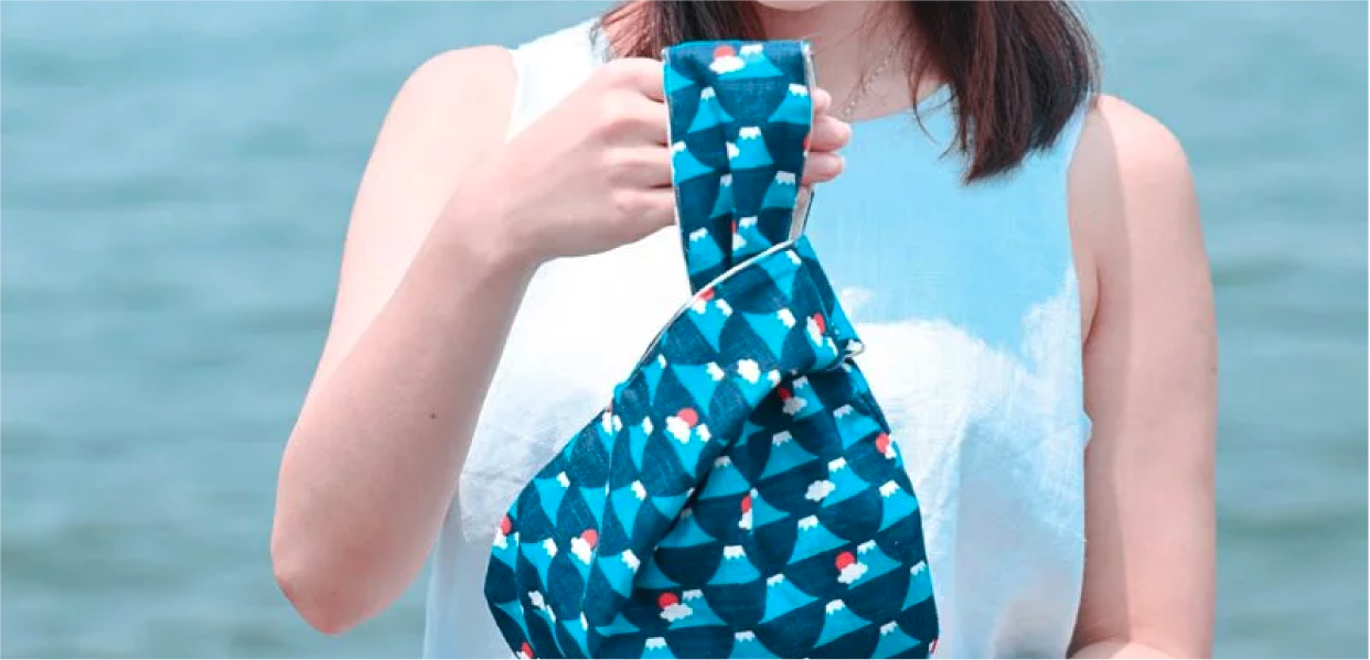 Blue Fuji Moonshell Bag held by a model at Grandmama Store in Hong Kong