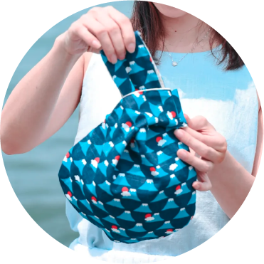 Blue Fuji Moonshell Bag in cotton-linen fabric held by a model at Grandmama Store in Hong Kong
