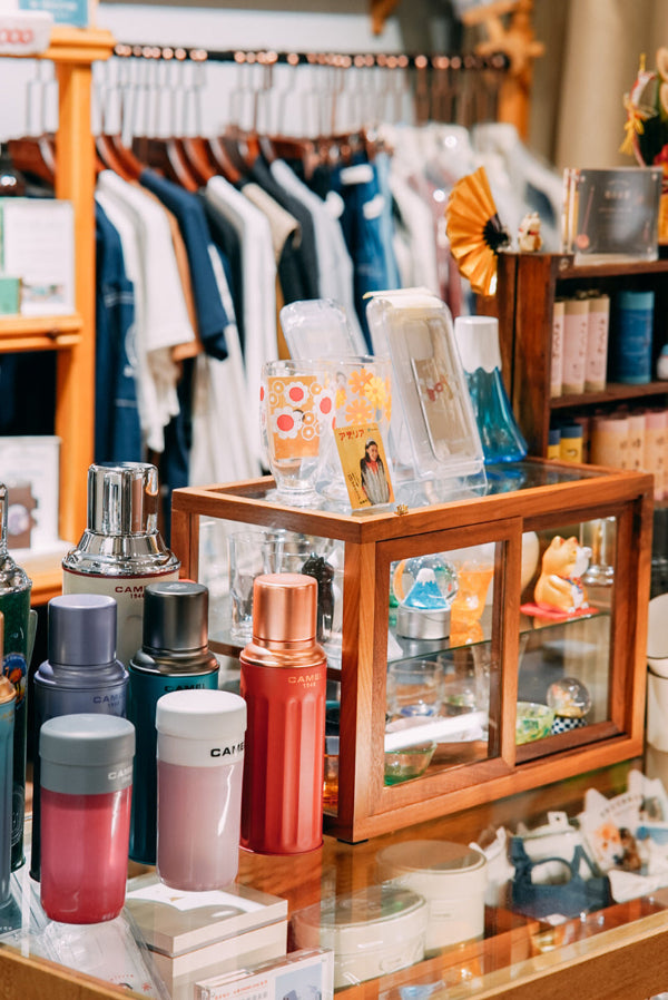 Boutique store environment displaying lifestyle accessories and clothing racks at Grandmama Store in Hong Kong.
