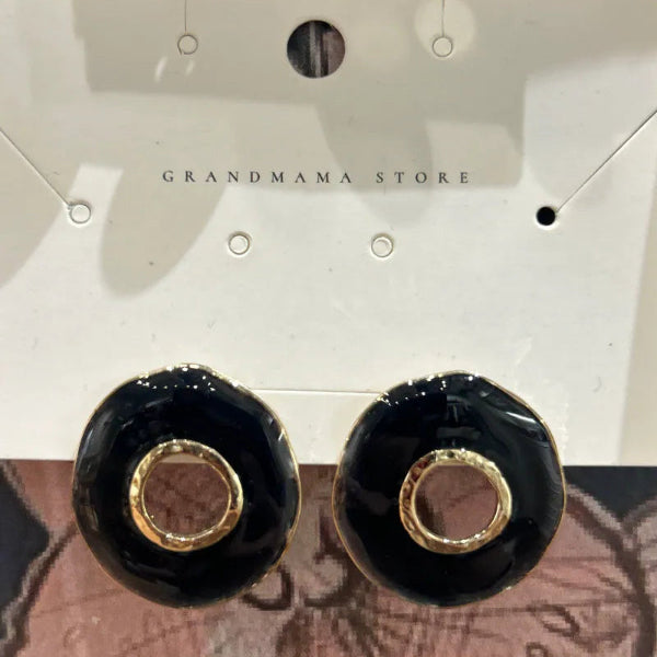 Chunky black enamel donut stud earrings with gold rim cutouts at Grandmama Store in Hong Kong