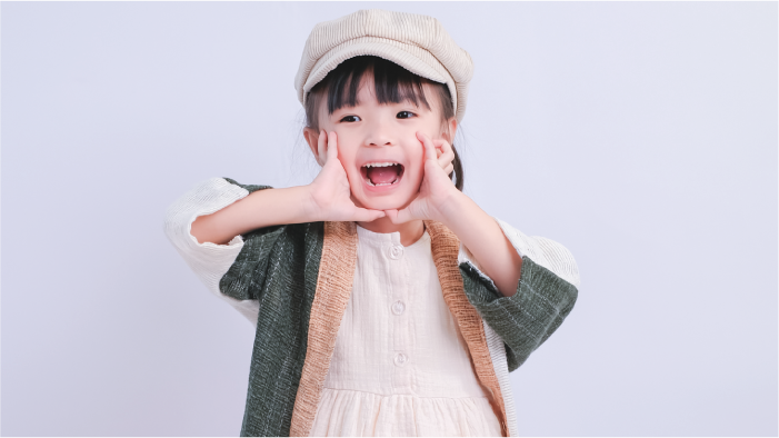 Close-up of young girl modeling Hand-cranked Kids Kimono in Sage Green at Grandmama Store in Hong Kong
