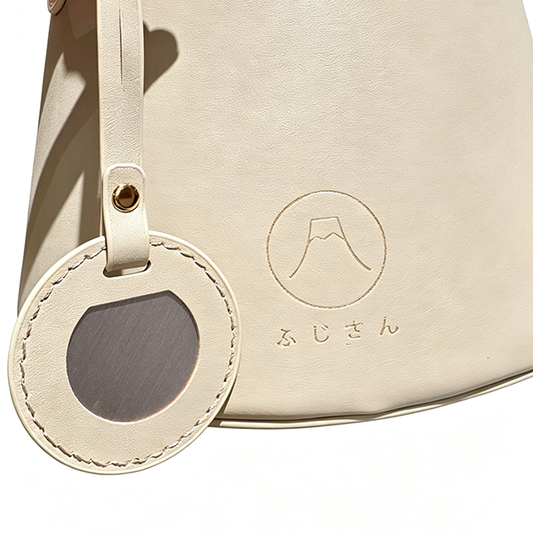 Debossed logo detail on Tea beige Mt. Fuji Goen Bag at Grandmama Store in Hong Kong