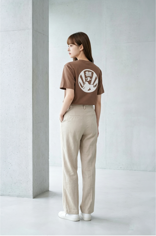 Female model wearing brown Kamon Tee-Lion Rock graphic T-shirt at Grandmama Store in Hong Kong