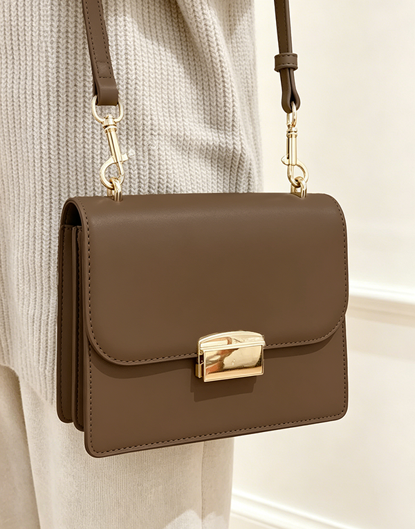 Front closure detail of dark brown Square Side Bag with Gold Buckle at Grandmama Store in Hong Kong