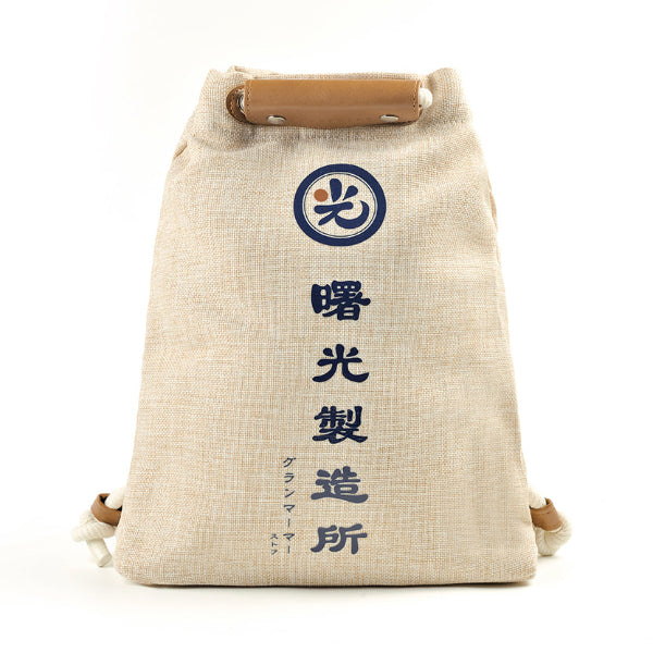 Front view of the beige linen Light of Dawn Sake Bag with blue Japanese text at Grandmama Store in Hong Kong.
