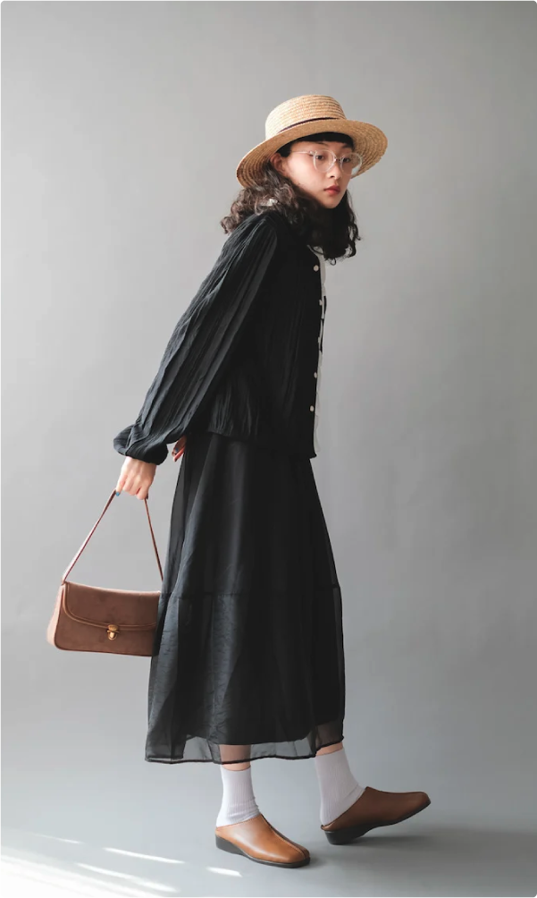 Full-length view of model wearing French Straw Boater Hat with a black dress at Grandmama Store in Hong Kong