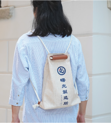 Light of Dawn Sake Bag beige drawstring backpack model lookbook photo at Grandmama Store in Hong Kong.