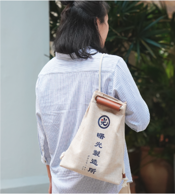 Light of Dawn Sake Bag beige single-shoulder drawstring bag lookbook photo at Grandmama Store in Hong Kong.