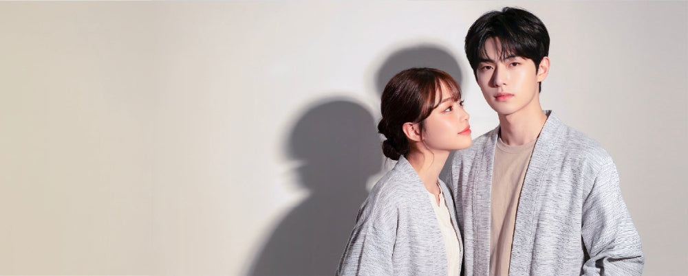 Male and female models wearing matching light grey Japanese kimono cardigans at Grandmama Store in Hong Kong.