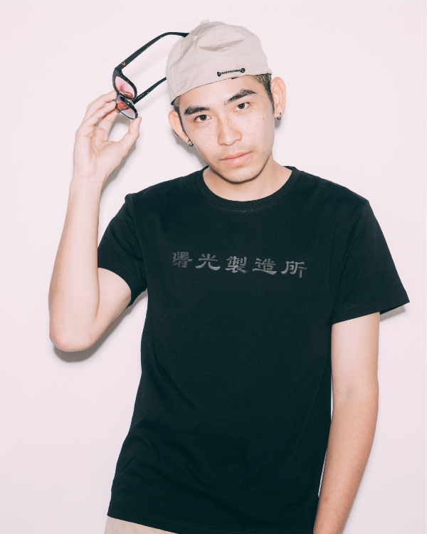 Male model wearing Life Matters Black Cotton Tee Light of Dawn with backwards cap at Grandmama Store in Hong Kong
