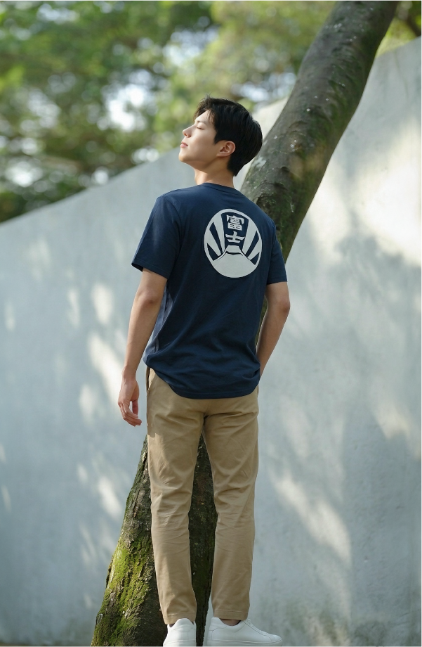 Male model wearing navy blue Kamon Tee Fujisan edition in a park setting at Grandmama Store in Hong Kong