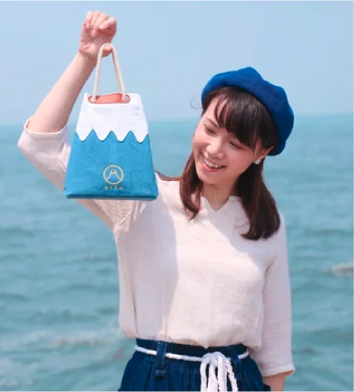 Model holding the light blue Mt. Fuji Sake Bag by hand at Grandmama Store in Hong Kong