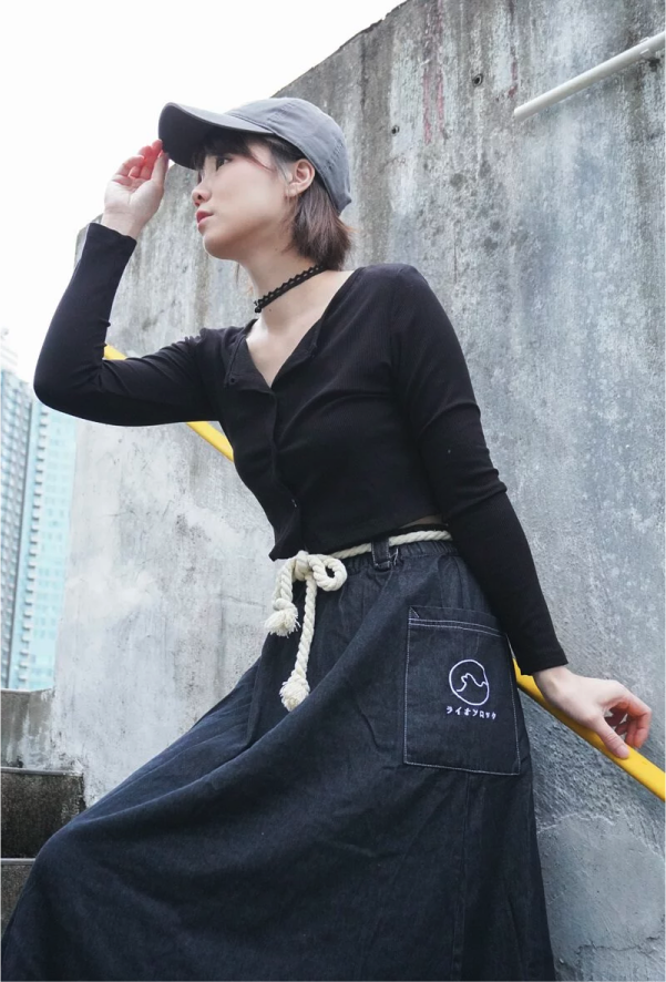 Model wearing Black Lion Rock Kamon Denim Dress posing outdoors at Grandmama Store in Hong Kong