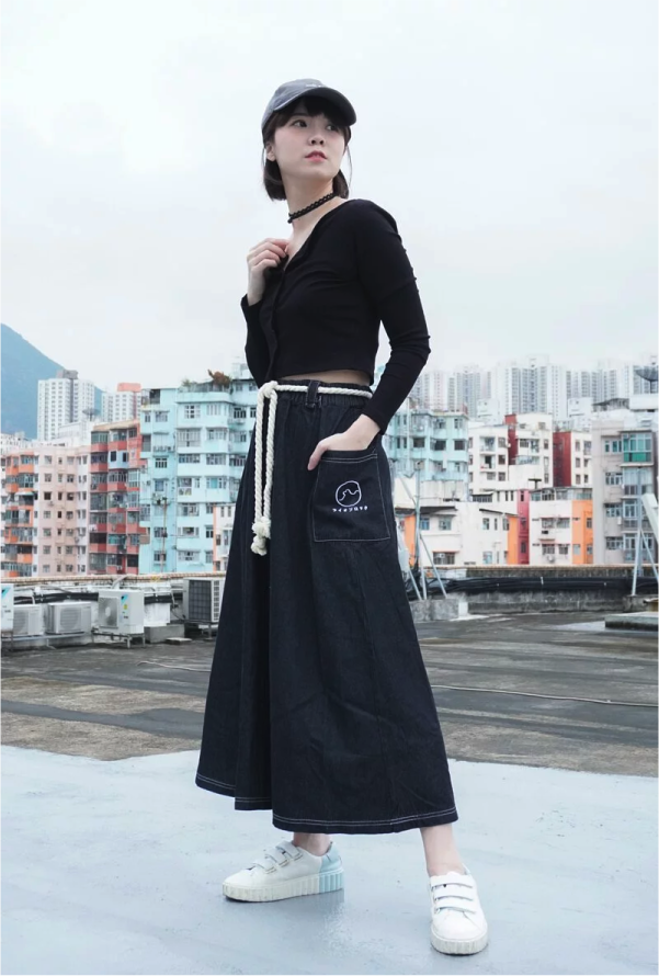 Model wearing Black Lion Rock Kamon Denim Dress with rope belt on a Hong Kong rooftop at Grandmama Store in Hong Kong