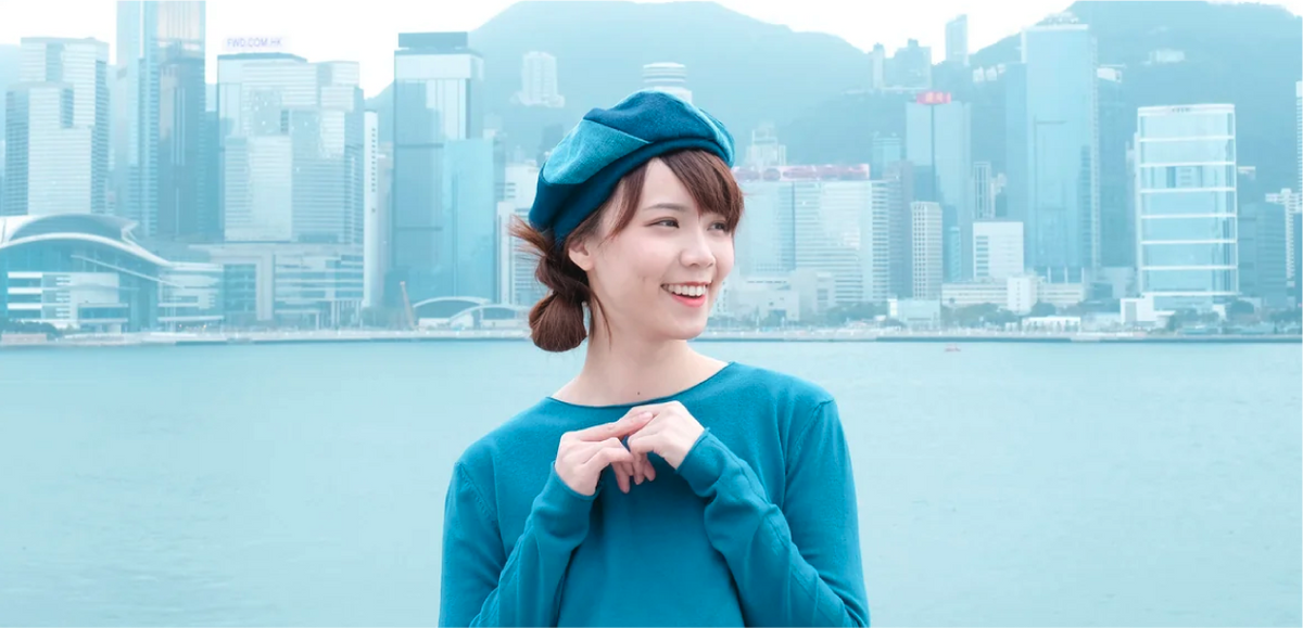 Model wearing a teal split-panel Sunshine Beret at Grandmama Store in Hong Kong