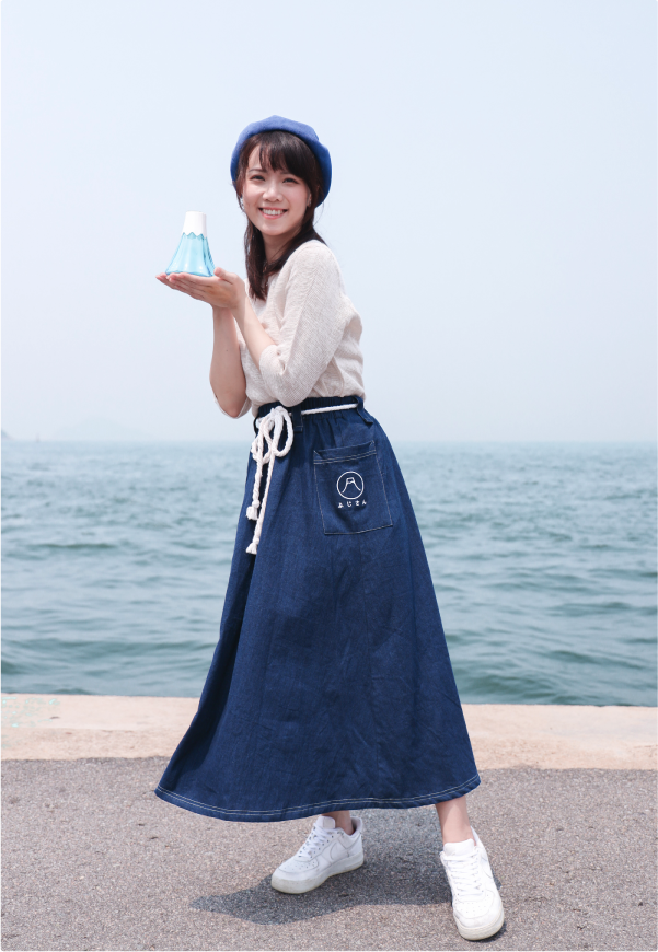 Model wearing navy blue Kamon Denim Dress Fujisan edition by the sea at Grandmama Store in Hong Kong