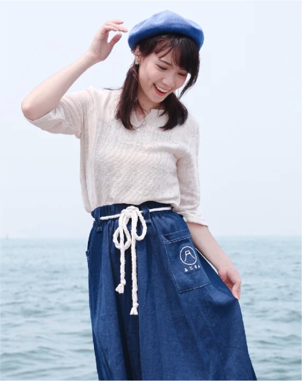 Model wearing navy blue Mt. Fuji Kamon Denim Dress by the sea at Grandmama Store in Hong Kong
