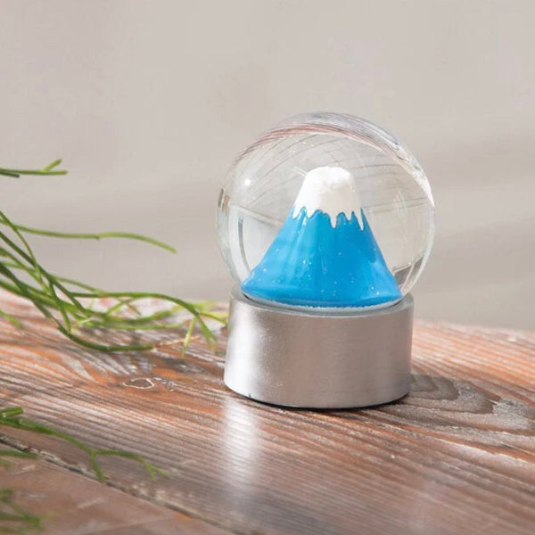 Mount Fuji Snowfall Crystal Globe on wooden table at Grandmama Store in Hong Kong
