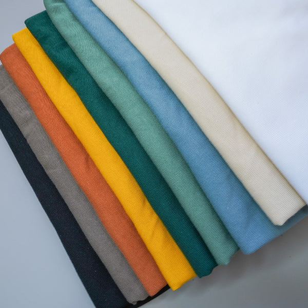 Stacked colorful Yama Basic Color Tees displayed at Grandmama Store in Hong Kong.