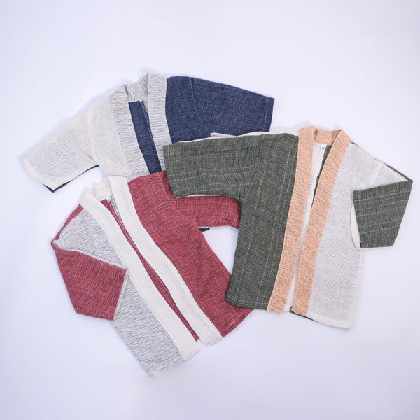 Three Hand-cranked Kids Kimono jackets laid out flat in all available colorways at Grandmama Store in Hong Kong.