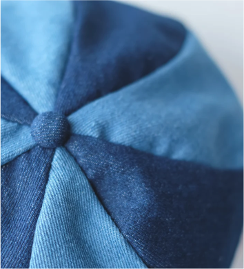 Top view close-up of Sunshine Beret denim crown and button detail at Grandmama Store in Hong Kong