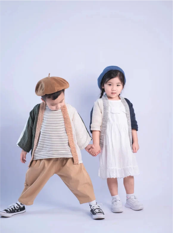 Two children modeling Hand-cranked Kids Kimonos in slub-knit cotton at Grandmama Store in Hong Kong