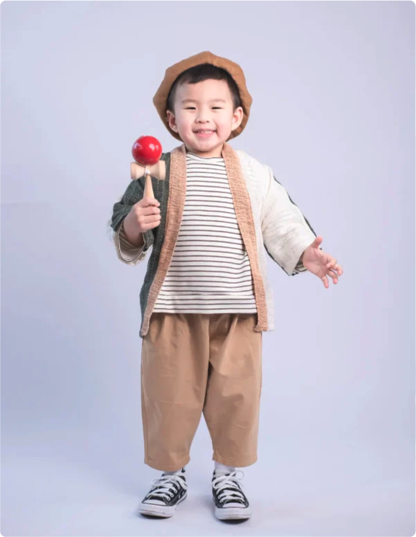 Young boy modeling Hand-cranked Kids Kimono in Sage Green & Cream at Grandmama Store in Hong Kong